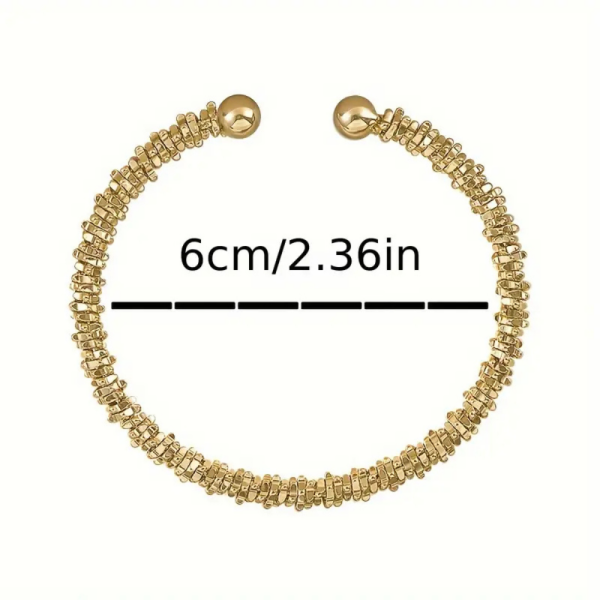 Gold-tone open cuff bracelet with irregular textured surface - size of bracelet