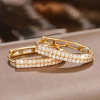 Gold circular hoop earrings with double row of sparkling zirconia - earring lay flat on display