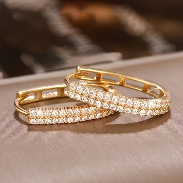 Gold circular hoop earrings with double row of sparkling zirconia - earring lay flat on display