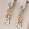 Gold crystal drop earrings with modern sculptural twist design
