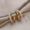 Gold huggie earrings with pearl detail and twist design