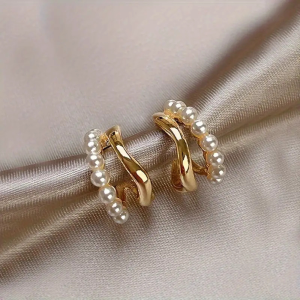 Gold huggie earrings with pearl detail and twist design