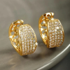 Small gold hoop earrings densely covered in synthetic zirconia